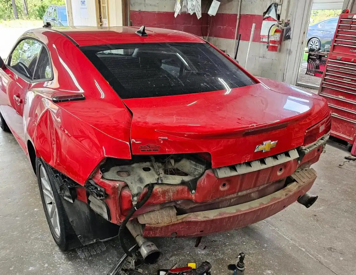 Chevrolet Camaro showing severe rear-end collision damage before repair at Covington’s Body Shop